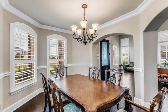 6309 Holbrook Cir, Parker, TX 75002 - dining space with arched walkways, a chandelier, crown molding, and dark wood-style flooring