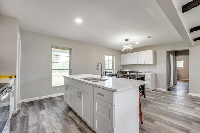 738 Campground Rd, Sherman, TX 75090 - kitchen with light wood-style floors, an island with sink, a chandelier, white cabinets, and recessed lighting