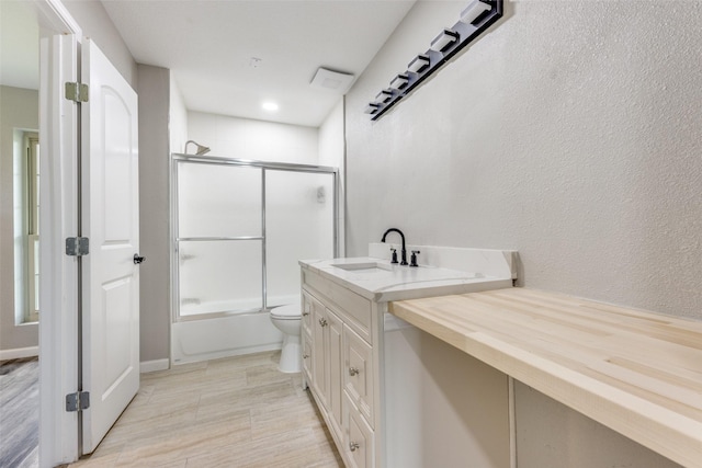 738 Campground Rd, Sherman, TX 75090 - bathroom with combined bath / shower with glass door, vanity, wood finished floors, and a textured wall