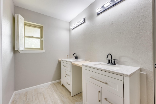 738 Campground Rd, Sherman, TX 75090 - bathroom with two vanities and wood finished floors