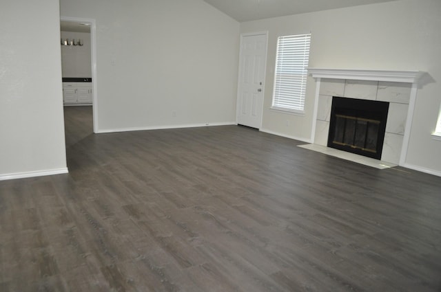 110 Myrtle Ave, Waxahachie, TX 75165 - unfurnished living room featuring a tiled fireplace, dark wood-type flooring, and lofted ceiling