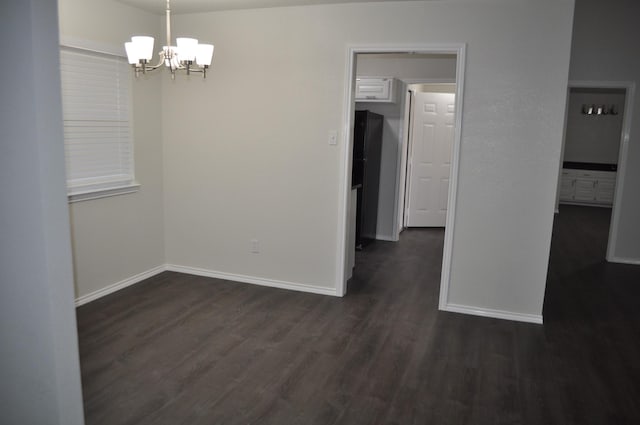 110 Myrtle Ave, Waxahachie, TX 75165 - empty room featuring dark wood-style floors and a chandelier