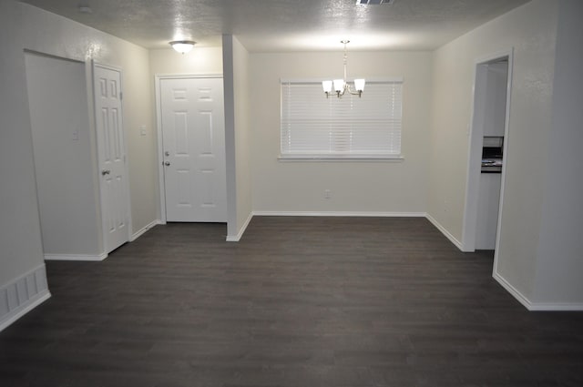 110 Myrtle Ave, Waxahachie, TX 75165 - unfurnished dining area with a chandelier and dark wood-type flooring