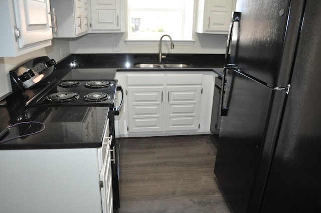 110 Myrtle Ave, Waxahachie, TX 75165 - kitchen with freestanding refrigerator, white cabinetry, dark wood-style floors, and electric range