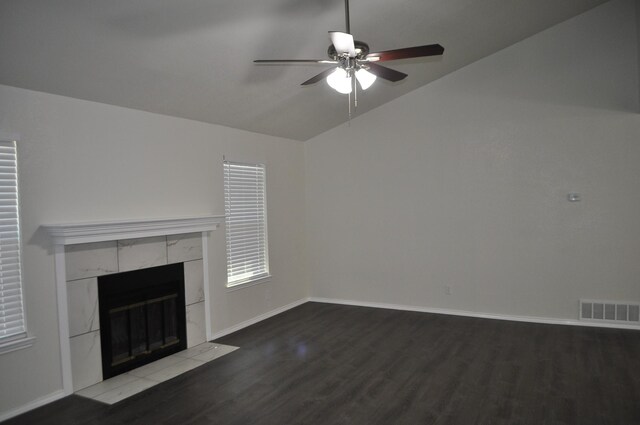 110 Myrtle Ave, Waxahachie, TX 75165 - unfurnished living room featuring a tiled fireplace, vaulted ceiling, wood finished floors, and a ceiling fan