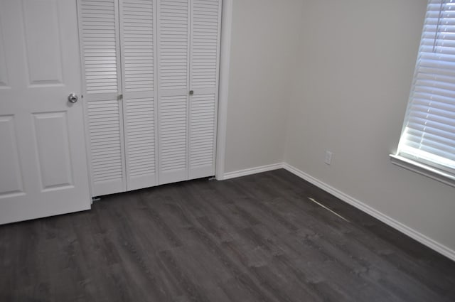 110 Myrtle Ave, Waxahachie, TX 75165 - unfurnished bedroom with a closet and dark wood-style flooring