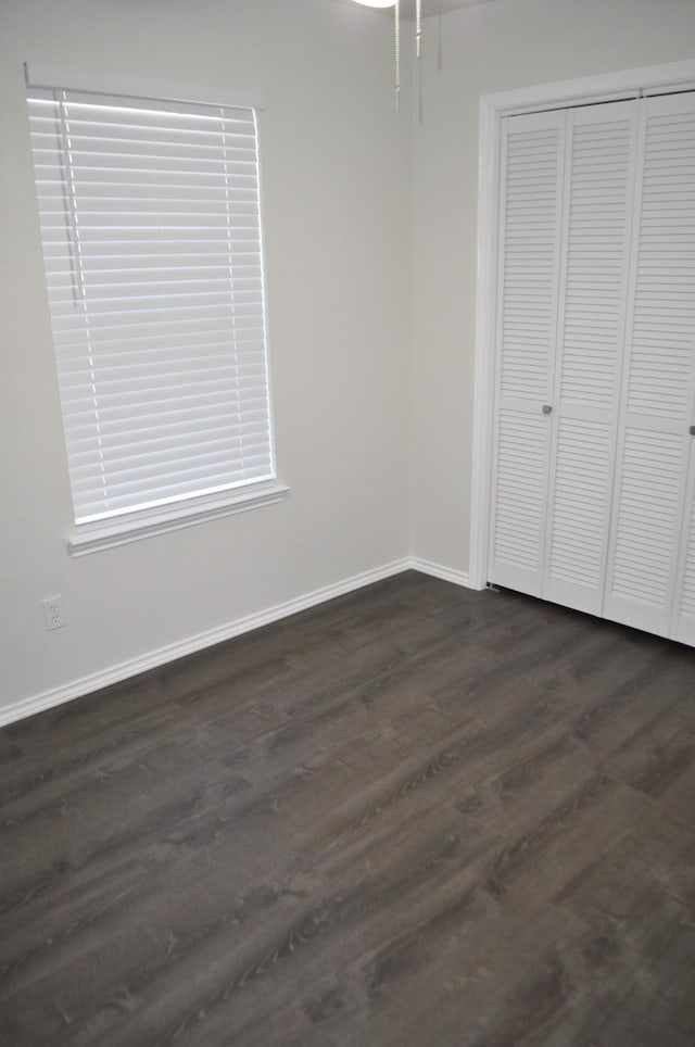 110 Myrtle Ave, Waxahachie, TX 75165 - unfurnished bedroom with dark wood finished floors and a closet