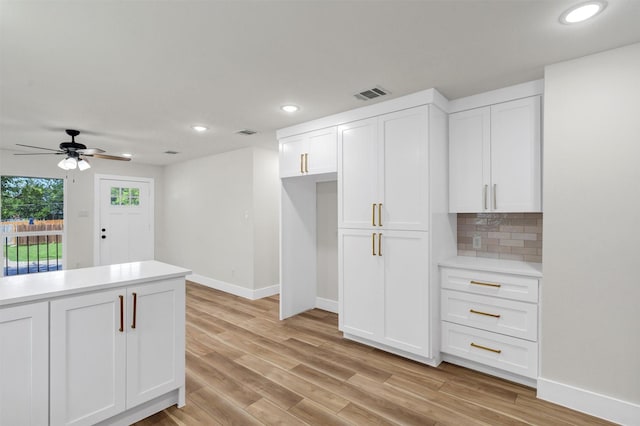 2917 NW Loraine St, Fort Worth, TX 76106 - kitchen with white cabinetry, light countertops, recessed lighting, light wood-style flooring, and backsplash