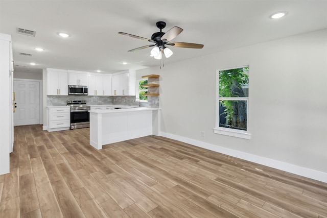 2917 NW Loraine St, Fort Worth, TX 76106 - kitchen with stainless steel appliances, healthy amount of natural light, a peninsula, light countertops, and recessed lighting