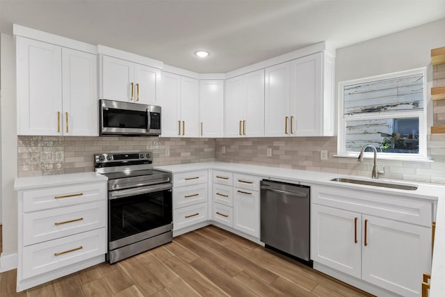 2917 NW Loraine St, Fort Worth, TX 76106 - kitchen featuring stainless steel appliances, light countertops, white cabinets, and recessed lighting