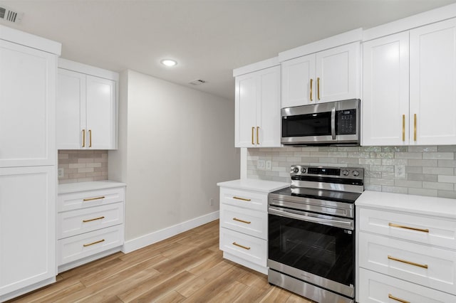 2917 NW Loraine St, Fort Worth, TX 76106 - kitchen featuring appliances with stainless steel finishes, light countertops, recessed lighting, light wood finished floors, and decorative backsplash