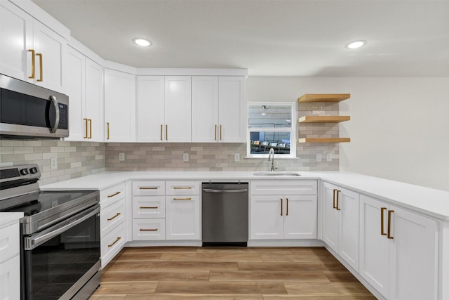 2917 NW Loraine St, Fort Worth, TX 76106 - kitchen featuring appliances with stainless steel finishes, light countertops, recessed lighting, and white cabinetry