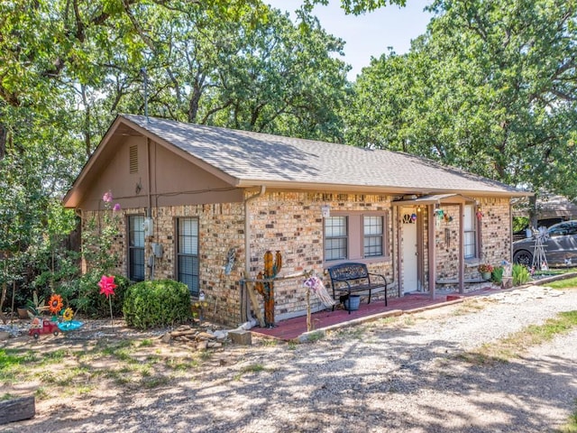 5403 Oakridge Rd, Joshua, TX 76058 - view of front of home featuring brick siding, a shingled roof, and covered porch