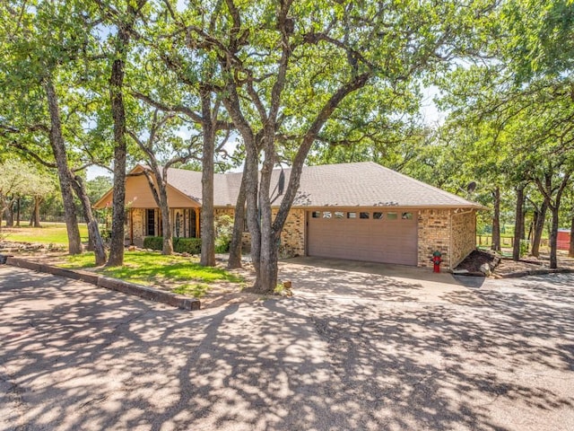 5403 Oakridge Rd, Joshua, TX 76058 - single story home featuring concrete driveway, a garage, brick siding, and roof with shingles