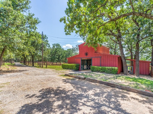 5403 Oakridge Rd, Joshua, TX 76058 - view of side of home with an outbuilding and board and batten siding