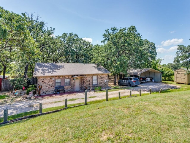 5403 Oakridge Rd, Joshua, TX 76058 - ranch-style home with a detached carport, a shed, driveway, and brick siding