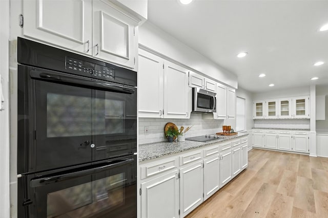 7407 Authon Dr, Dallas, TX 75248 - kitchen featuring black appliances, white cabinetry, recessed lighting, light stone countertops, and tasteful backsplash