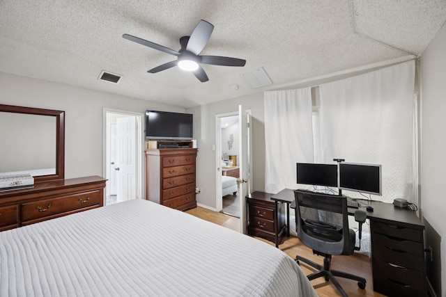 1502 Bette Dr, Mesquite, TX 75149 - bedroom featuring light wood-style floors, an office area, a ceiling fan, and a textured ceiling