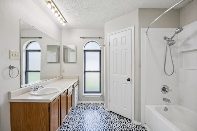 1502 Bette Dr, Mesquite, TX 75149 - bathroom with bathtub / shower combination, vanity, a textured ceiling, and tile patterned floors