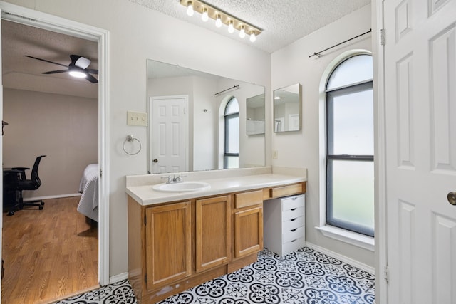 1502 Bette Dr, Mesquite, TX 75149 - ensuite bathroom with vanity, plenty of natural light, a textured ceiling, and a ceiling fan