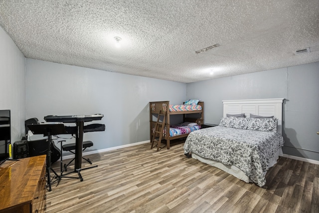 1502 Bette Dr, Mesquite, TX 75149 - bedroom featuring wood finished floors and a textured ceiling