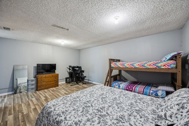 1502 Bette Dr, Mesquite, TX 75149 - bedroom featuring wood finished floors and a textured ceiling