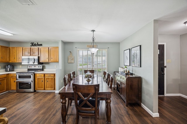 1502 Bette Dr, Mesquite, TX 75149 - dining area with dark wood-type flooring and baseboards