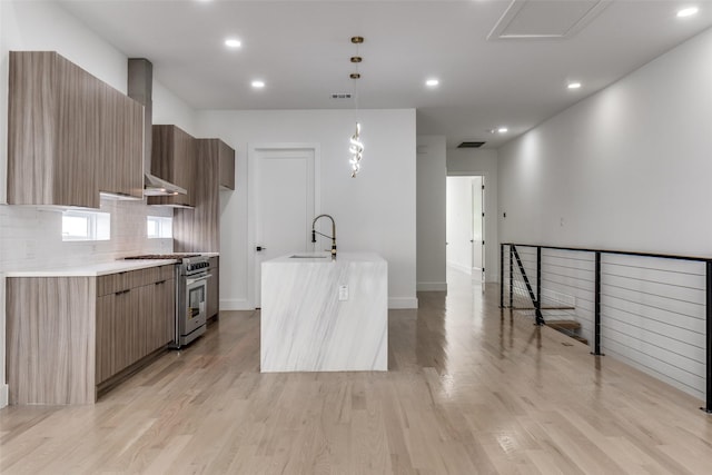 1521 N Haskell Ave, Dallas, TX 75204 - kitchen with stainless steel range, modern cabinets, wall chimney range hood, light countertops, and recessed lighting