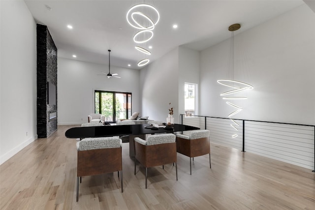 1521 N Haskell Ave, Dallas, TX 75204 - dining room featuring light wood-style floors, a chandelier, ceiling fan, a towering ceiling, and recessed lighting