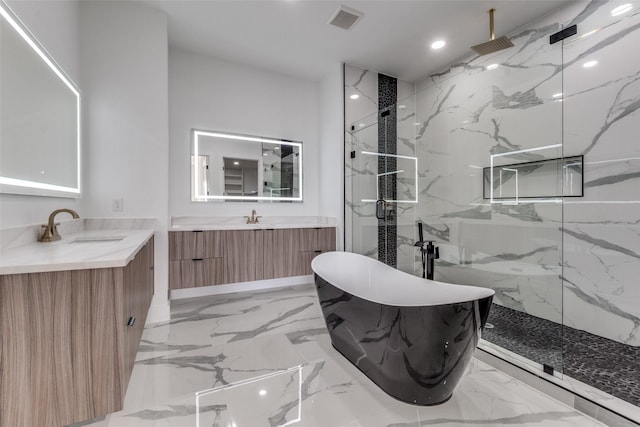 1521 N Haskell Ave, Dallas, TX 75204 - full bathroom featuring marble tiled flooring, a marble finish shower, a freestanding bath, recessed lighting, and two vanities