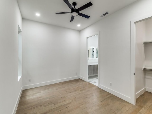 1521 N Haskell Ave, Dallas, TX 75204 - unfurnished bedroom featuring a walk in closet, light wood-style flooring, recessed lighting, ensuite bath, and a closet