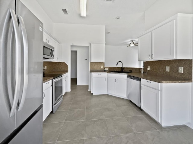 6020 Maple Leaf Dr, Arlington, TX 76017 - kitchen featuring stainless steel appliances, backsplash, light tile patterned floors, dark countertops, and ceiling fan