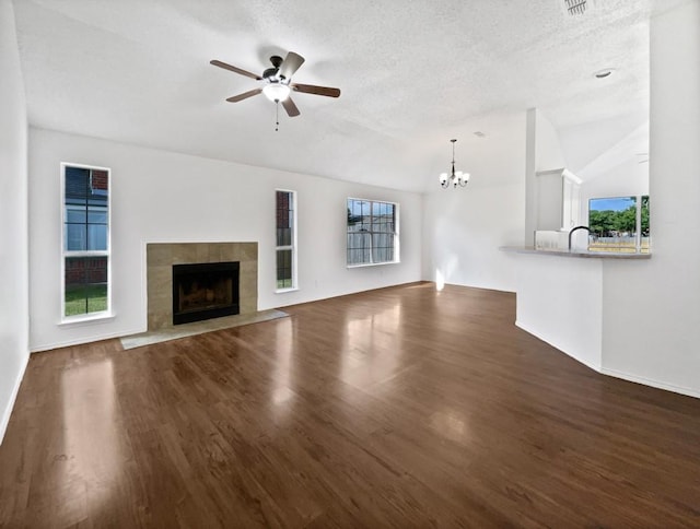 6020 Maple Leaf Dr, Arlington, TX 76017 - unfurnished living room featuring ceiling fan, wood finished floors, plenty of natural light, and a textured ceiling