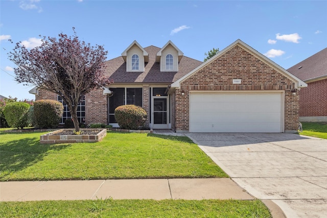 7807 Raton Ridge Ln, Arlington, TX 76002 - view of front of home with brick siding, a garage, a front yard, and driveway