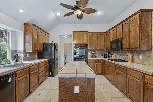 7807 Raton Ridge Ln, Arlington, TX 76002 - kitchen featuring black appliances, ceiling fan, tasteful backsplash, lofted ceiling, and tile counters