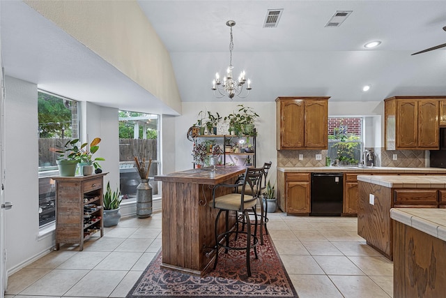 7807 Raton Ridge Ln, Arlington, TX 76002 - kitchen featuring black dishwasher, tile counters, healthy amount of natural light, light tile patterned floors, and recessed lighting