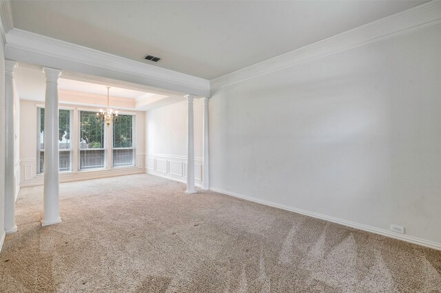 1041 Woodbriar Dr, Grapevine, TX 76051 - carpeted empty room featuring ornamental molding, a chandelier, ornate columns, a decorative wall, and a tray ceiling