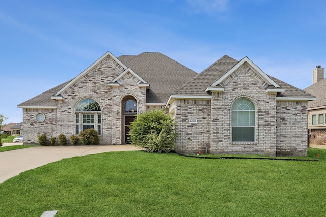 6602 Orange Blossom Dr, Midlothian, TX 76065 - french provincial home featuring brick siding, a front yard, and roof with shingles