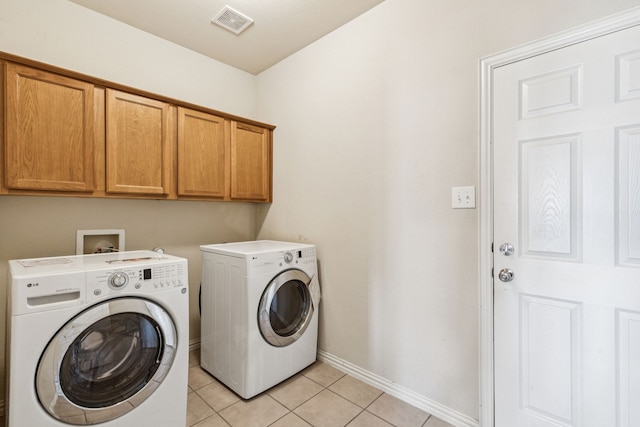 6602 Orange Blossom Dr, Midlothian, TX 76065 - laundry area with independent washer and dryer, cabinet space, and light tile patterned floors