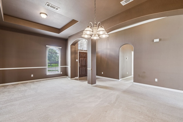 6602 Orange Blossom Dr, Midlothian, TX 76065 - carpeted empty room featuring arched walkways, a chandelier, and a raised ceiling