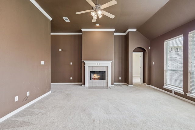 6602 Orange Blossom Dr, Midlothian, TX 76065 - unfurnished living room featuring a ceiling fan, light carpet, arched walkways, a fireplace, and lofted ceiling