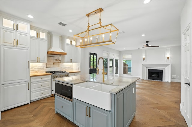2705 Jackson Dr, Melissa, TX 75454 - kitchen featuring appliances with stainless steel finishes, custom range hood, gray cabinets, ceiling fan, and white cabinets