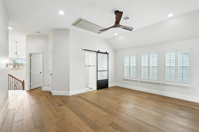 2705 Jackson Dr, Melissa, TX 75454 - spare room with a ceiling fan, lofted ceiling, attic access, hardwood / wood-style flooring, and a barn door