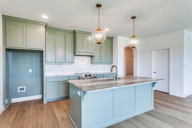 304 Ridge Dr, Justin, TX 76247 - kitchen featuring stainless steel electric range oven, arched walkways, light wood-style floors, light stone counters, and recessed lighting