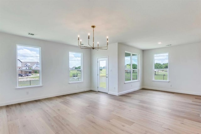 304 Ridge Dr, Justin, TX 76247 - unfurnished room featuring a chandelier and light wood-type flooring