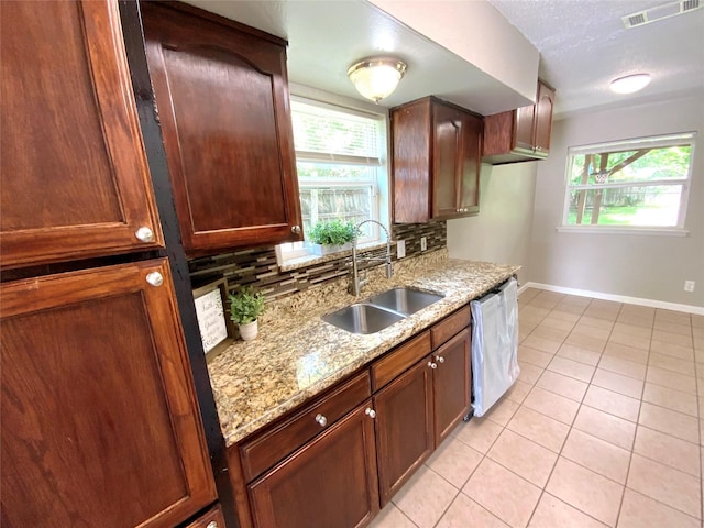 6509 Woodway Dr, Fort Worth, TX 76133 - kitchen featuring dishwasher, tasteful backsplash, light tile patterned flooring, and light stone countertops