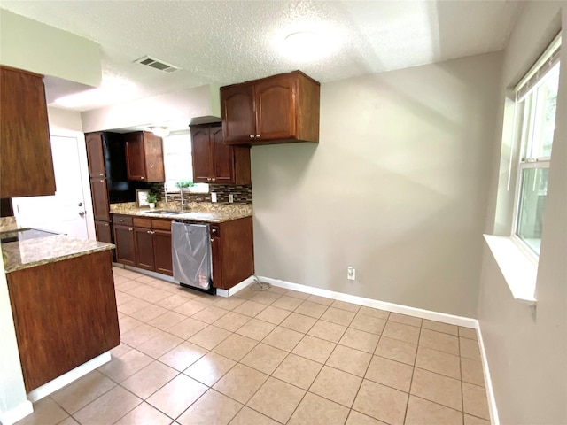 6509 Woodway Dr, Fort Worth, TX 76133 - kitchen featuring dishwasher, plenty of natural light, backsplash, light tile patterned floors, and a textured ceiling
