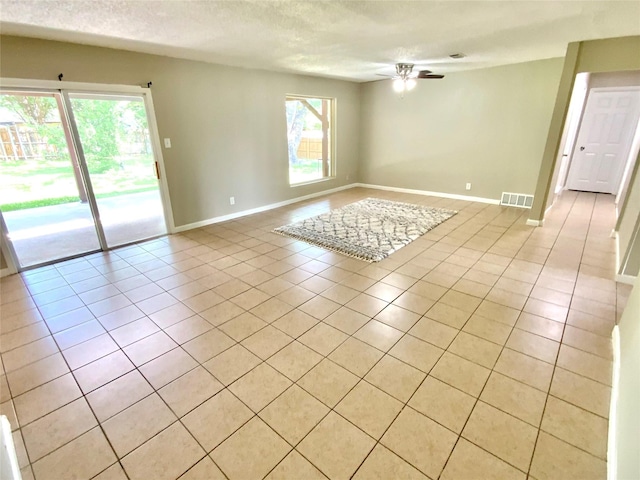 6509 Woodway Dr, Fort Worth, TX 76133 - unfurnished room featuring a ceiling fan, light tile patterned floors, and a textured ceiling