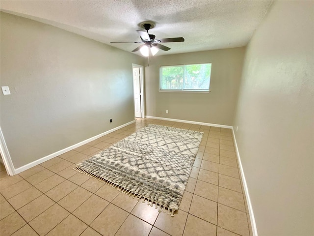 6509 Woodway Dr, Fort Worth, TX 76133 - spare room with light tile patterned floors, ceiling fan, and a textured ceiling