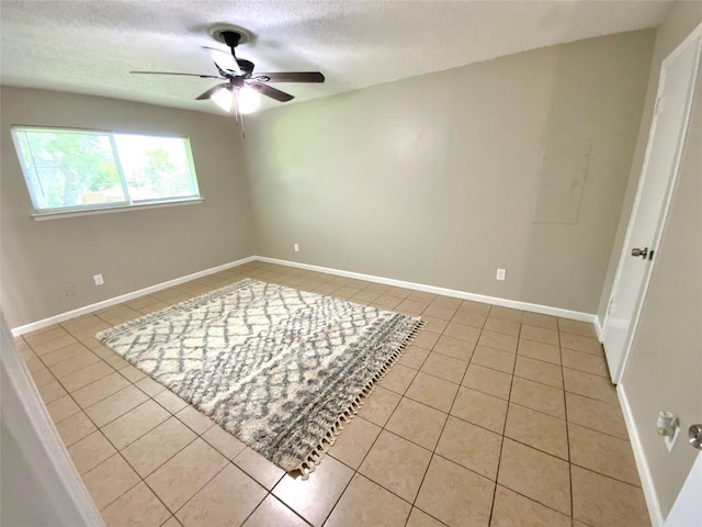 6509 Woodway Dr, Fort Worth, TX 76133 - spare room with light tile patterned floors, ceiling fan, and a textured ceiling